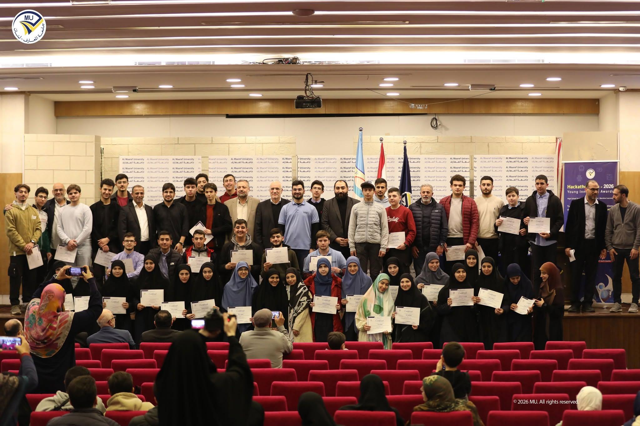 Students holding certificates on stage at a school hackathon awards ceremony